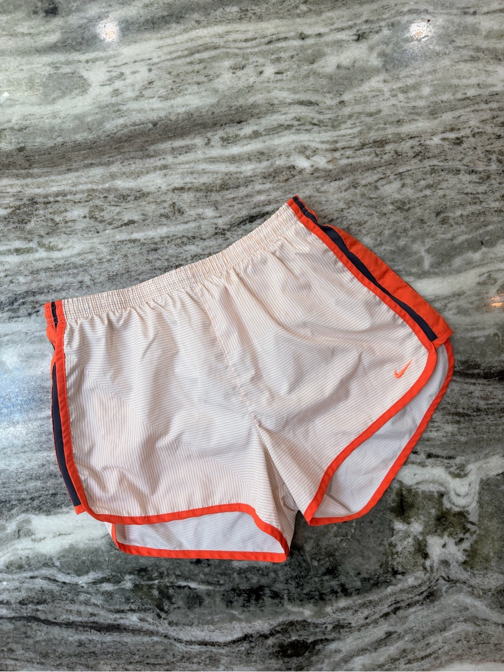 Nike Women’s White Athletic Shorts with Orange Trim and Stripe Accents